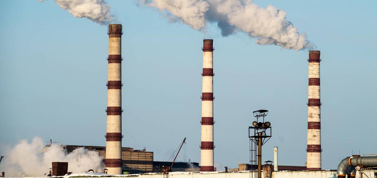 fábrica con chimeneas echando humo