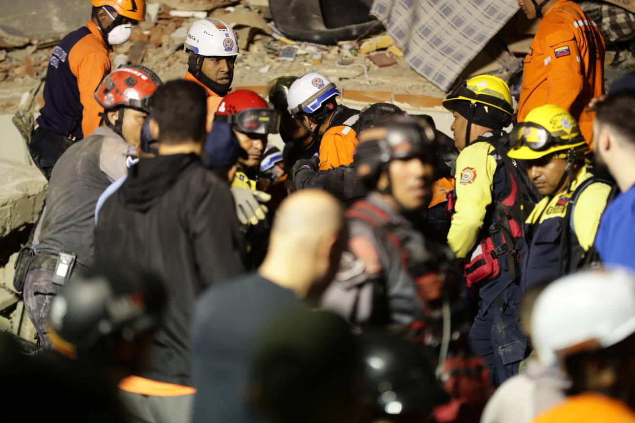 Integrantes de cuerpos de emergencia buscan víctimas este miércoles